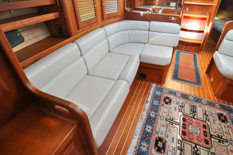 Jezebel Yacht Photos Pics Luxurious 2004 Sabre 426 yacht interior with elegant wood finish and plush seating.