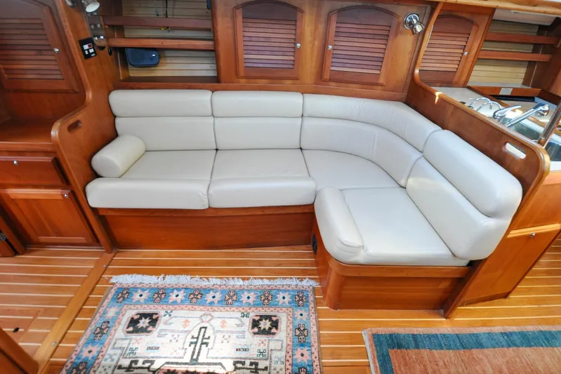 Jezebel Yacht Photos Pics Luxurious 2004 Sabre 426 yacht interior with plush seating and elegant wooden finishes.