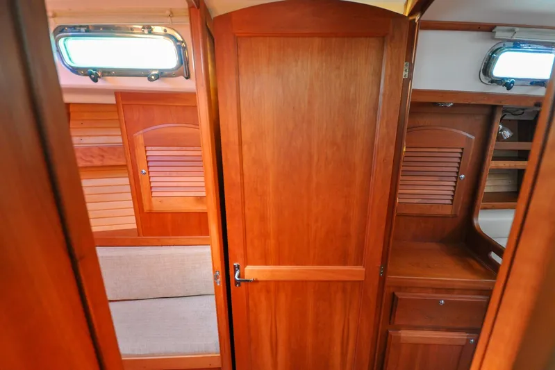 Jezebel Yacht Photos Pics Interior of 2004 Sabre 426 yacht with wooden cabinetry and seating area.