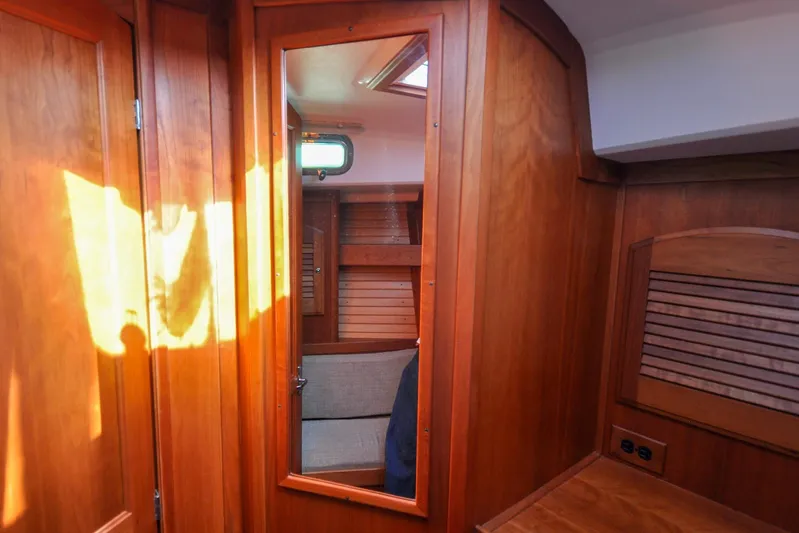Jezebel Yacht Photos Pics Interior of 2004 Sabre 426 yacht with wooden paneling and mirror reflection.
