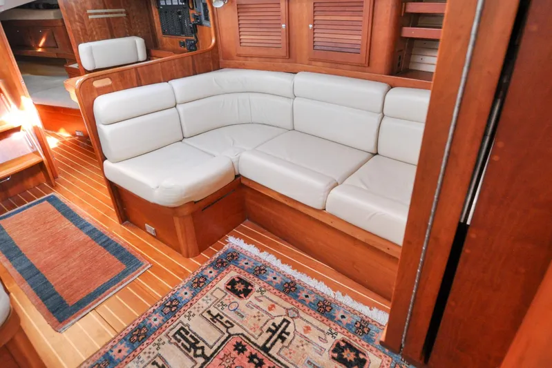 Jezebel Yacht Photos Pics Luxurious 2004 Sabre 426 yacht interior with plush seating and elegant wood finish.