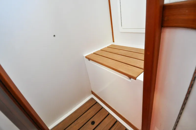 Jezebel Yacht Photos Pics Wooden interior of 2004 Sabre 426 boat, featuring bench and flooring.