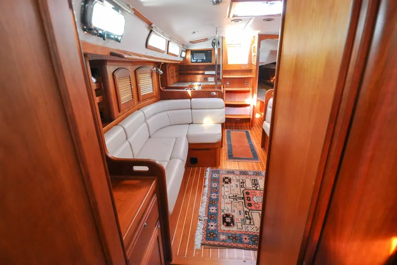 Jezebel Yacht Photos Pics Luxurious interior of 2004 Sabre 426 yacht with elegant wood finish and cozy seating.