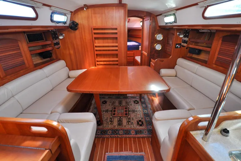 Jezebel Yacht Photos Pics Interior of 2004 Sabre 426 yacht with wooden furnishings and cozy seating area.