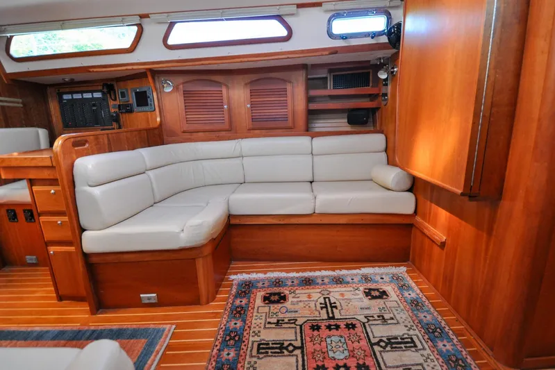 Jezebel Yacht Photos Pics Luxurious 2004 Sabre 426 yacht interior with plush seating and elegant wood finish.
