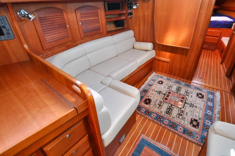 Jezebel Yacht Photos Pics Luxurious 2004 Sabre 426 yacht interior with elegant wood finish and cozy seating area.