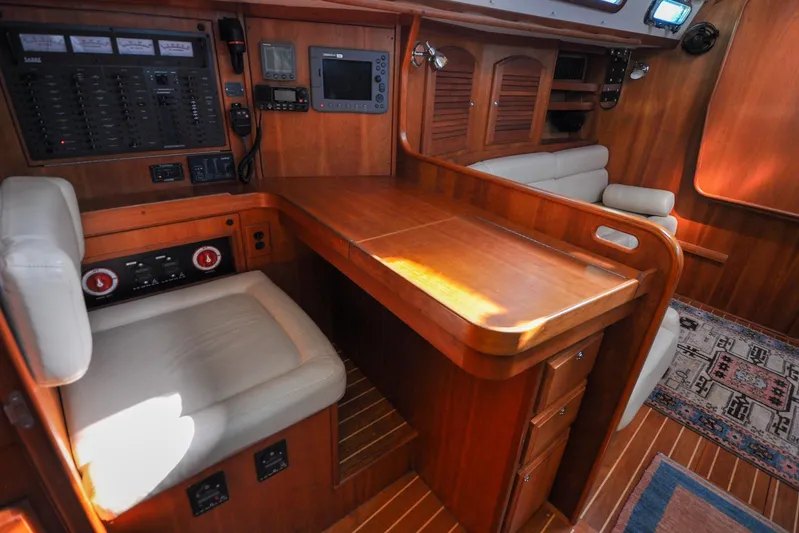 Jezebel Yacht Photos Pics 2004 Sabre 426 yacht interior with navigation station and wooden cabinetry.