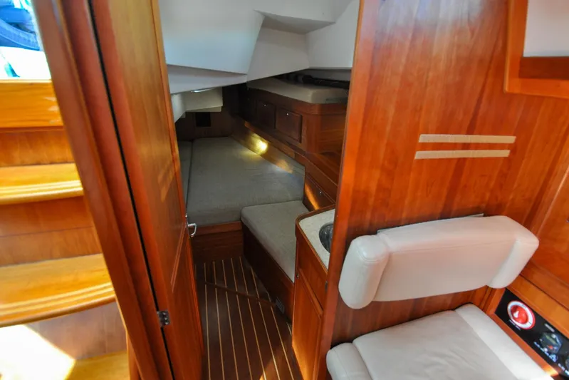 Jezebel Yacht Photos Pics 2004 Sabre 426 yacht interior with wooden finish and cozy sleeping area.