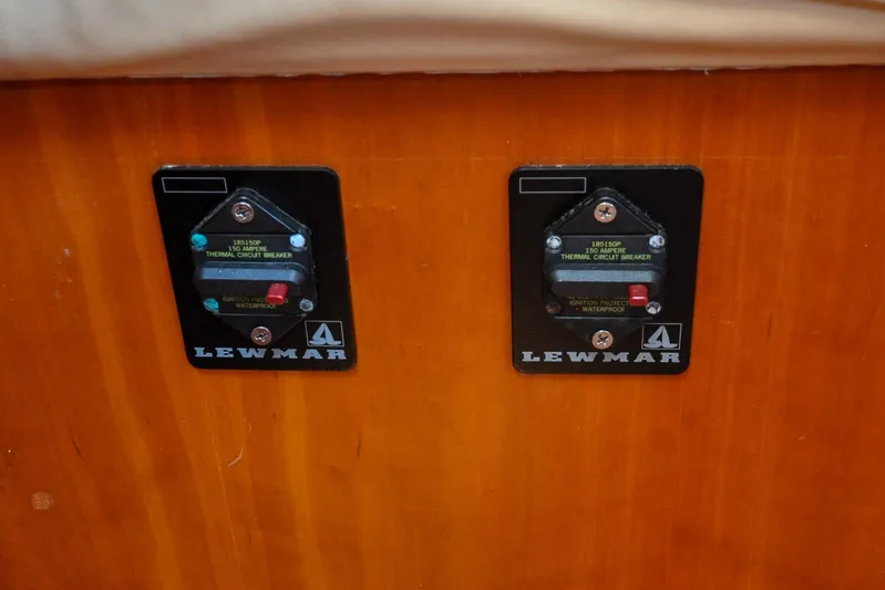 Jezebel Yacht Photos Pics Two Lewmar thermal circuit breakers on a wooden panel, Sabre 426, 2004 model.