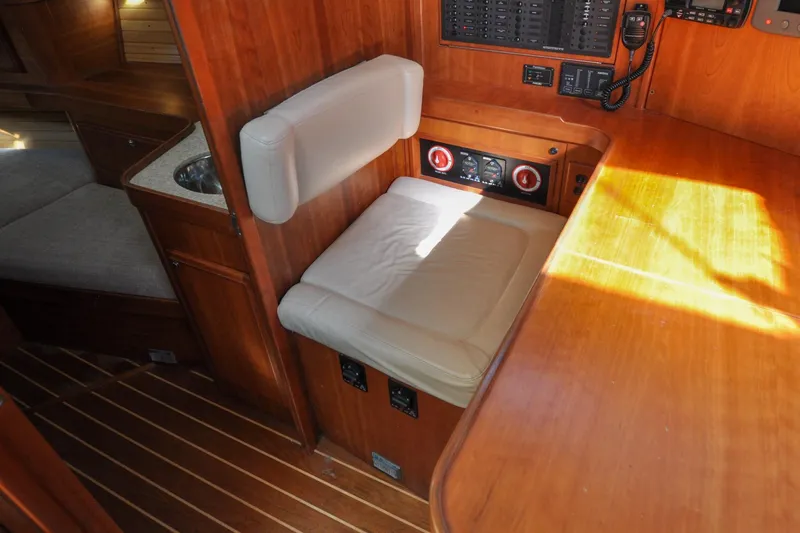 Jezebel Yacht Photos Pics Interior of 2004 Sabre 426 yacht with wooden finish and cushioned seating.