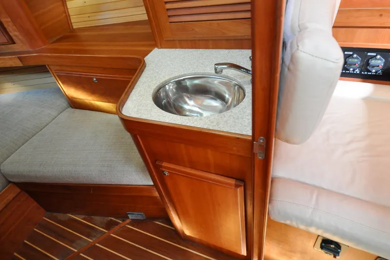 Jezebel Yacht Photos Pics Interior of 2004 Sabre 426 yacht with wooden cabinetry and compact sink.