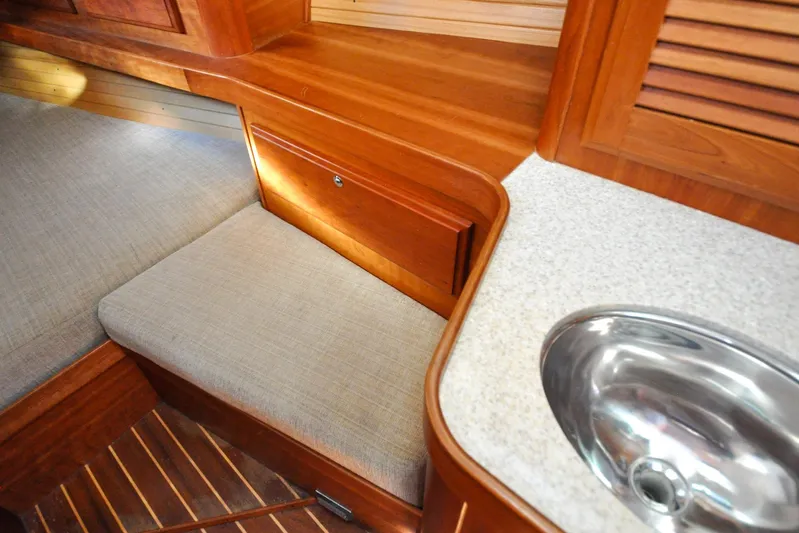 Jezebel Yacht Photos Pics Interior of 2004 Sabre 426 yacht with wooden finish and compact sink.