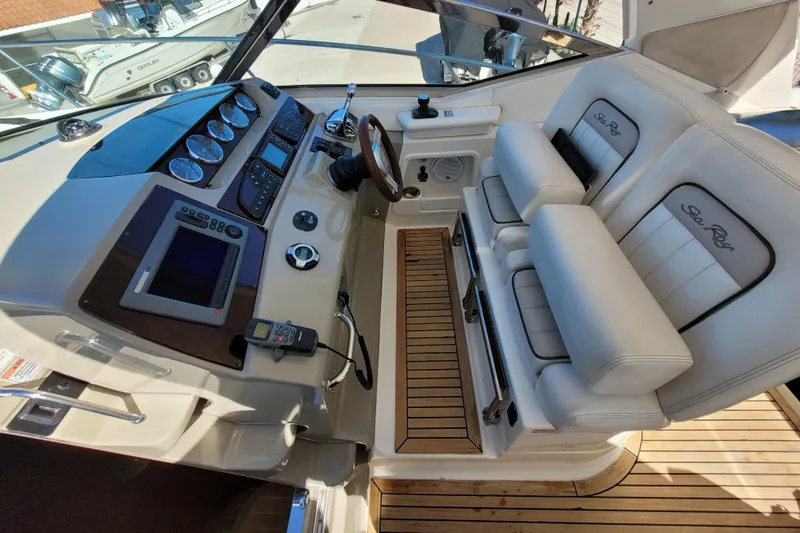  Yacht Photos Pics Helm of 2011 Sea Ray 370 Sundancer with leather seats and modern controls.