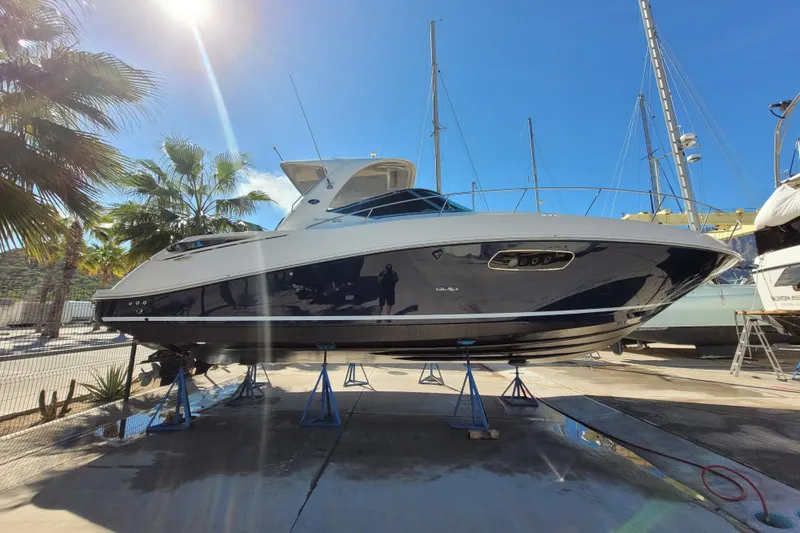  Yacht Photos Pics 2011 Sea Ray 370 Sundancer yacht on stands, sunny day, palm trees in background.