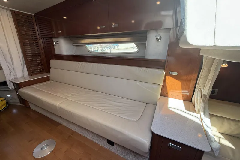  Yacht Photos Pics Interior of 2011 Sea Ray 370 Sundancer with beige leather seating and wooden cabinetry.