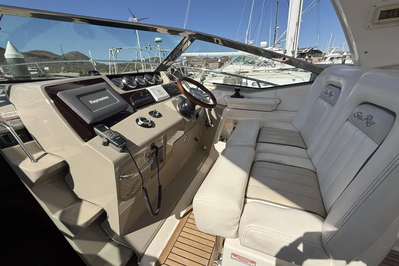  Yacht Photos Pics 2011 Sea Ray 370 Sundancer helm with leather seating and modern navigation equipment.
