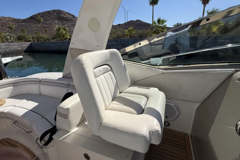 Yacht Photos Pics 2011 Sea Ray 370 Sundancer cockpit with white seating, docked near palm trees.