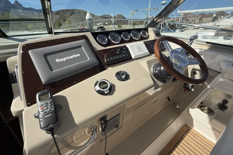  Yacht Photos Pics Helm of 2011 Sea Ray 370 Sundancer with Raymarine navigation system and wooden steering wheel.