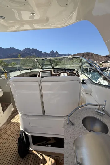  Yacht Photos Pics 2011 Sea Ray 370 Sundancer yacht cockpit with mountain view, featuring helm and sink.