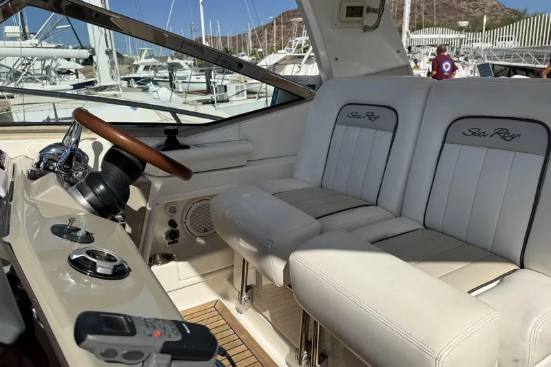  Yacht Photos Pics 2011 Sea Ray 370 Sundancer cockpit with white seating and wooden steering wheel at marina.