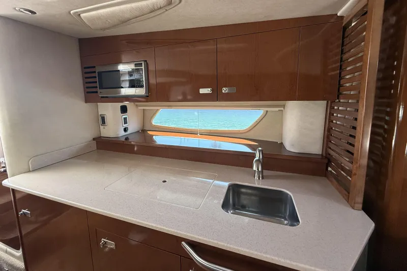  Yacht Photos Pics Interior of 2011 Sea Ray 370 Sundancer yacht kitchen with sink and microwave.