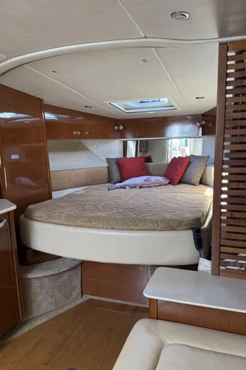  Yacht Photos Pics Luxurious interior of 2011 Sea Ray 370 Sundancer yacht with cozy bed and elegant decor.