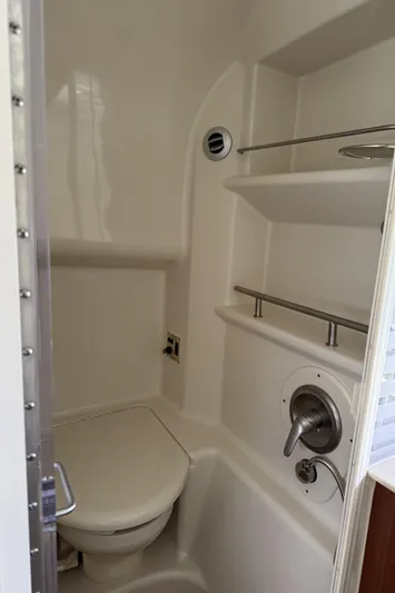  Yacht Photos Pics 2011 Sea Ray 370 Sundancer bathroom with compact toilet and shelves.