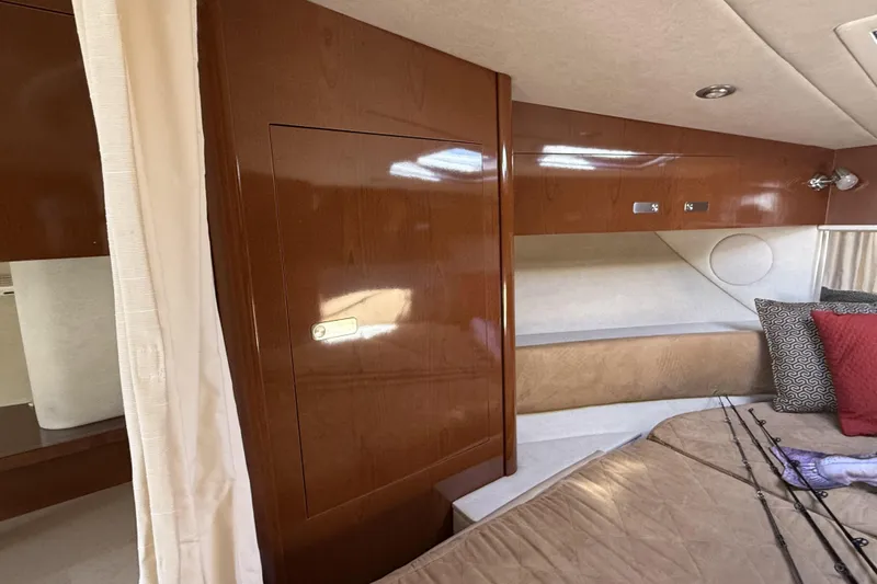  Yacht Photos Pics Interior cabin of 2011 Sea Ray 370 Sundancer with wood paneling and bedding.