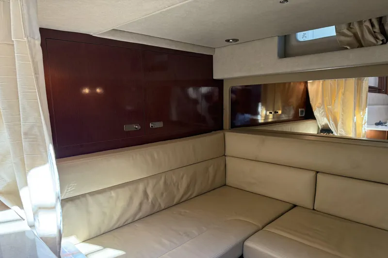  Yacht Photos Pics Interior of 2011 Sea Ray 370 Sundancer with beige seating and wooden cabinetry.