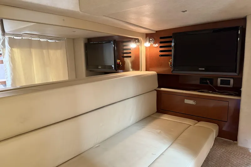  Yacht Photos Pics Interior of 2011 Sea Ray 370 Sundancer with beige seating and wall-mounted TV.