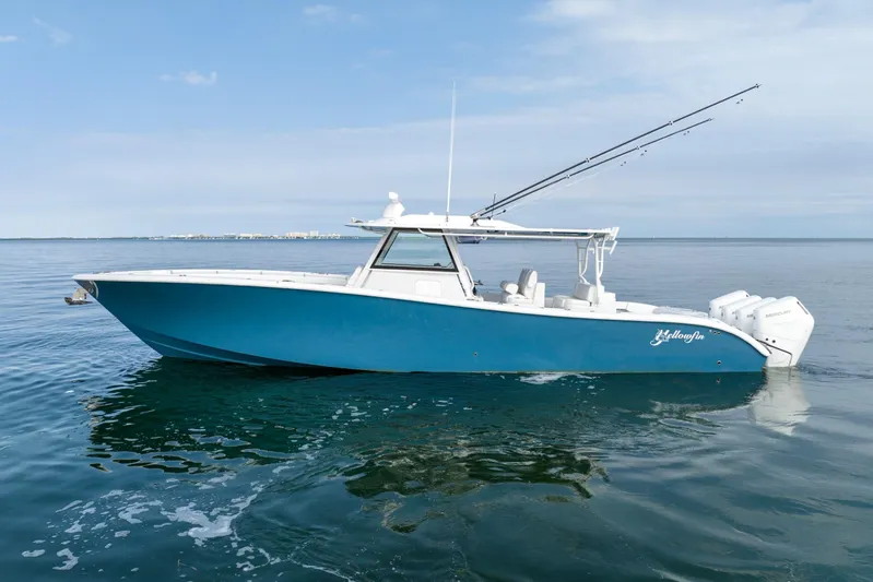  Yacht Photos Pics 2024 Yellowfin 42 boat on calm water with fishing rods.