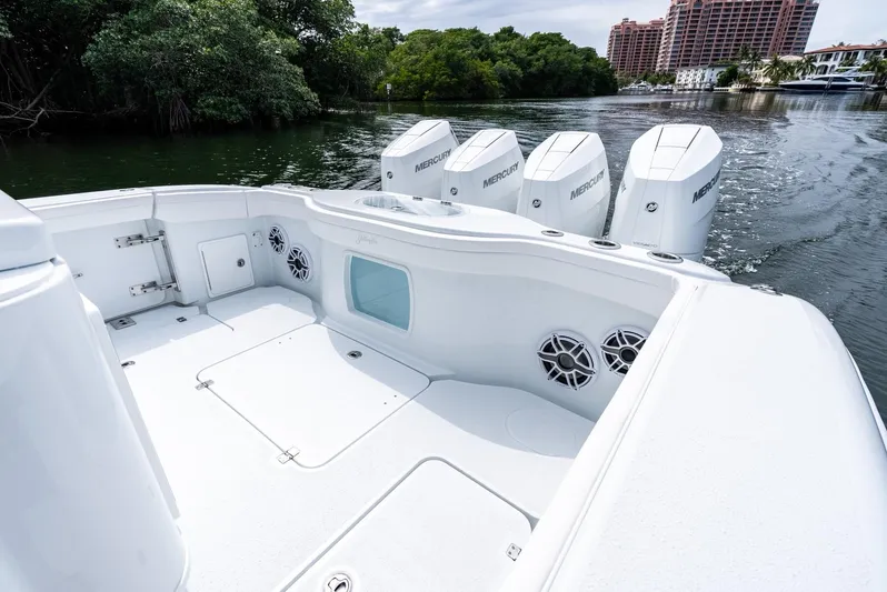  Yacht Photos Pics 2024 Yellowfin 42 boat with quad Mercury outboard engines on a calm waterway.