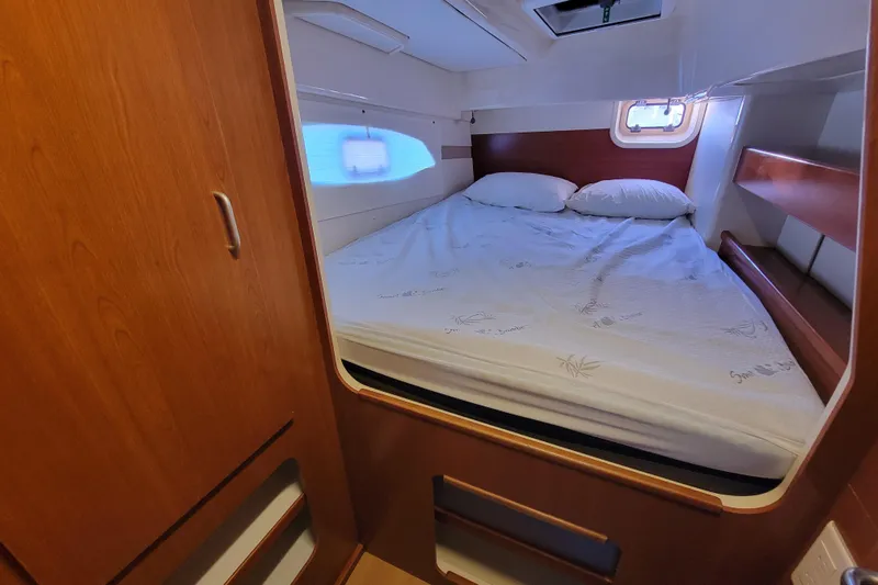 Finding Anemoi Yacht Photos Pics Cozy bedroom in 2014 Leopard 39 yacht with wooden cabinetry and natural light.