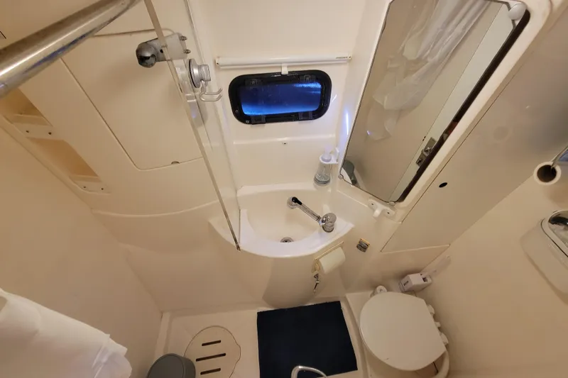 Finding Anemoi Yacht Photos Pics Compact bathroom in a 2014 Leopard 39 yacht, featuring sink, toilet, and shower.
