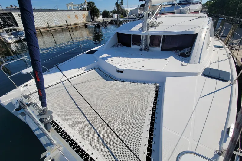 Finding Anemoi Yacht Photos Pics 2014 Leopard 39 catamaran docked at a marina, featuring spacious deck and netting.