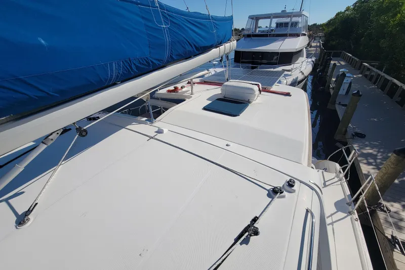 Finding Anemoi Yacht Photos Pics 2014 Leopard 39 catamaran with blue sail cover docked beside another boat.