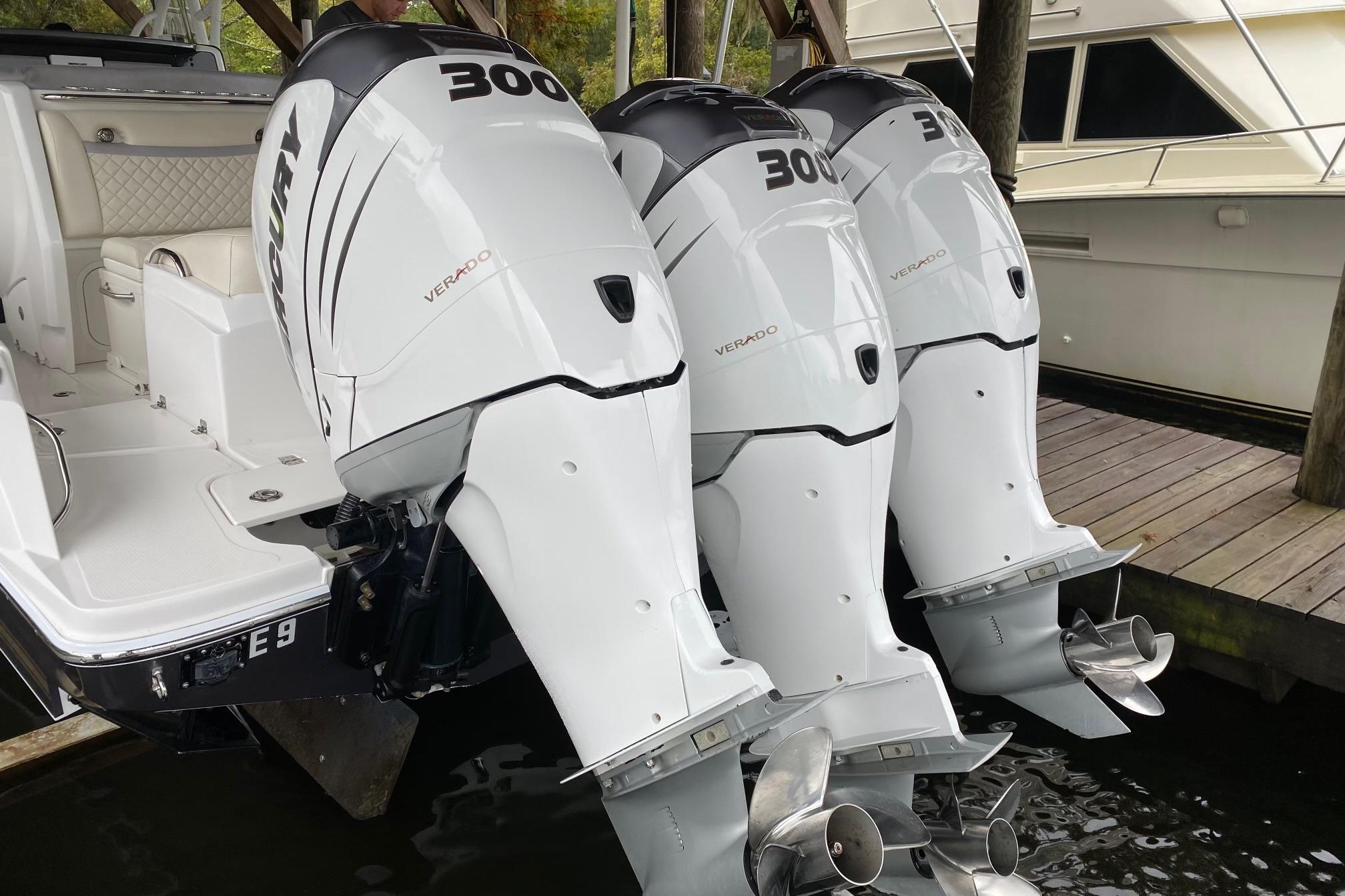 2014 Nor-Tech 340 Sport Center Console with triple Mercury Verado 300 engines docked.