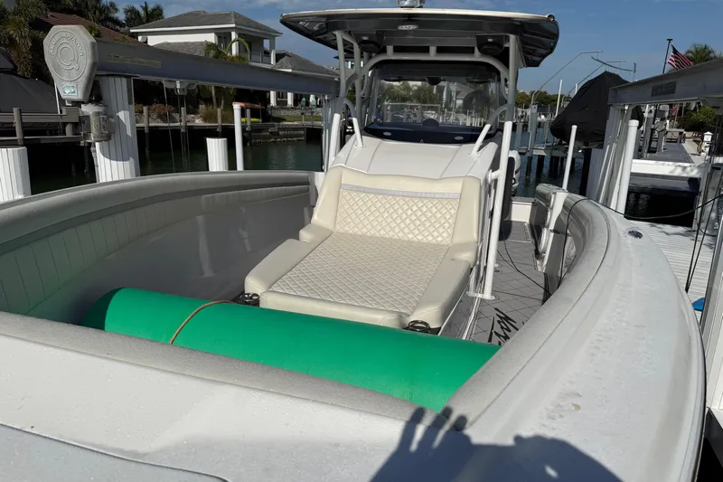  Yacht Photos Pics 2014 Nor-Tech 340 Sport Center Console boat with cushioned seating and docked in a marina.