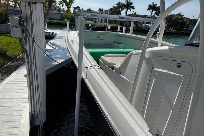  Yacht Photos Pics 2014 Nor-Tech 340 Sport Center Console docked by a waterfront with palm trees.