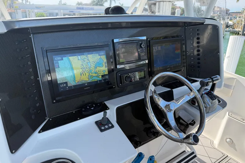  Yacht Photos Pics 2014 Nor-Tech 340 Sport Center Console dashboard with navigation screens and steering wheel.