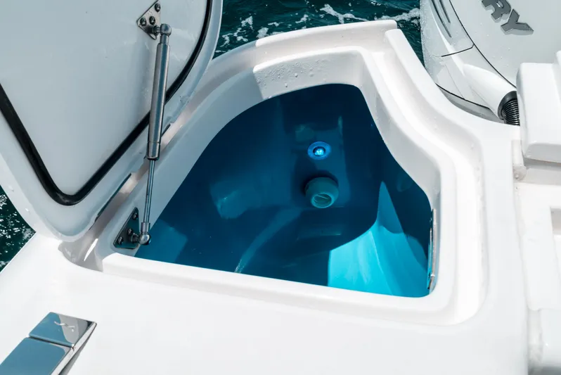  Yacht Photos Pics 2022 Intrepid 407 Nomad FE boat's open storage compartment with blue interior.