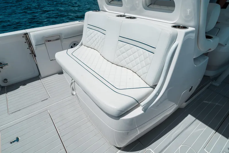  Yacht Photos Pics 2022 Intrepid 407 Nomad FE boat seating with white upholstery and ocean backdrop.