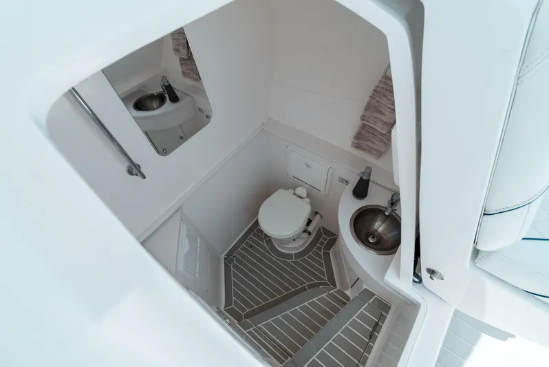  Yacht Photos Pics 2022 Intrepid 407 Nomad FE boat bathroom with toilet and sink.