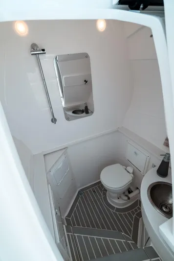  Yacht Photos Pics 2022 Intrepid 407 Nomad FE boat bathroom with modern fixtures and compact design.