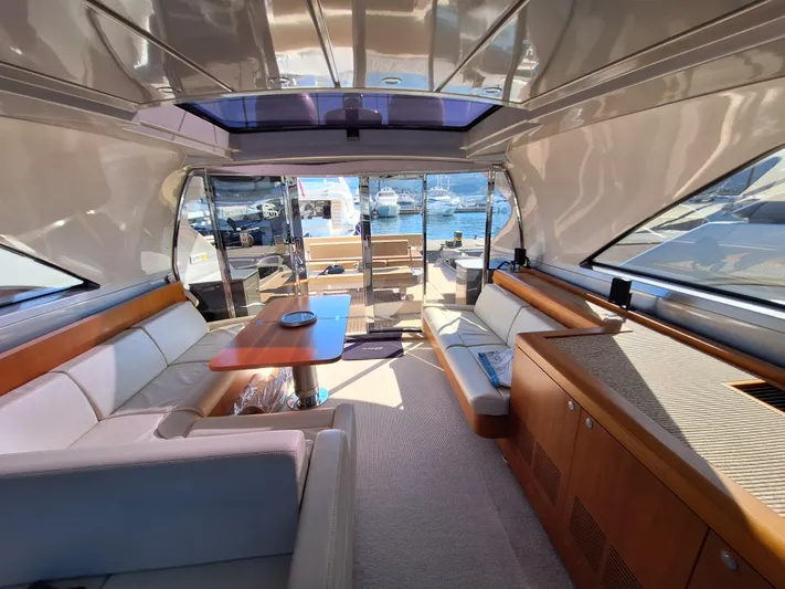 Vida II Yacht Photos Pics Luxurious interior of a 2007 Riva 68 Ego yacht with elegant seating and wooden accents.