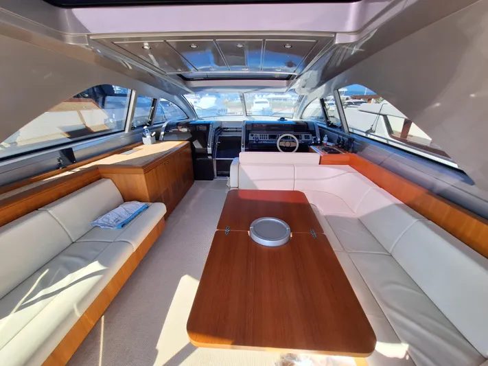 Vida II Yacht Photos Pics Luxurious interior of a 2007 Riva 68 Ego yacht with elegant seating and wooden table.
