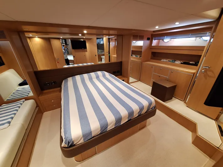 Vida II Yacht Photos Pics Luxurious cabin interior of 2007 Riva 68 Ego yacht with striped bedding.