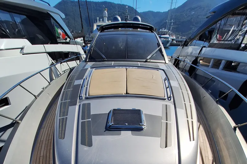 Vida II Yacht Photos Pics 2007 Riva 68 Ego yacht docked between other boats, showcasing sleek design and luxury features.