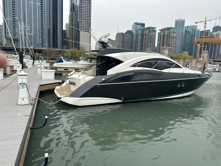  Yacht Photos Pics 2008 Marquis 40 SC yacht docked in urban marina with city skyline.