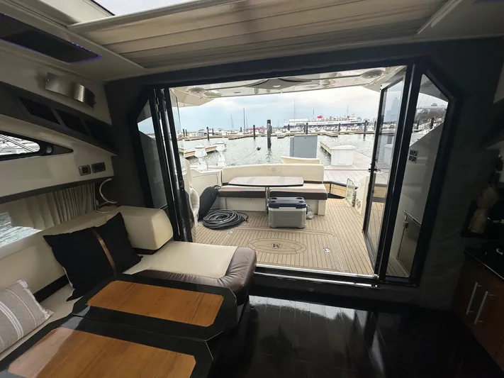  Yacht Photos Pics Interior view of 2008 Marquis 40 SC yacht with open deck and marina backdrop.